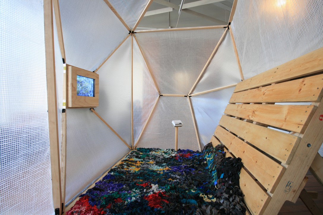 Andy Irving and Keila Martin, Apocalypse Tent, 2012, handmade rug and surveillance screen. Image courtesy of Lance Cash.