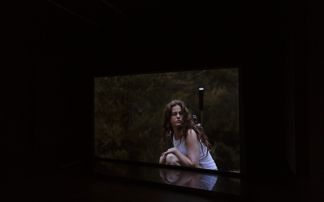 Henrietta Fisher, Funny how I'm always on the head of a longing arrow, 2024, single-channel 4k video, custom aluminium tray, water, installation view. Image courtesy of Cheska Brown.