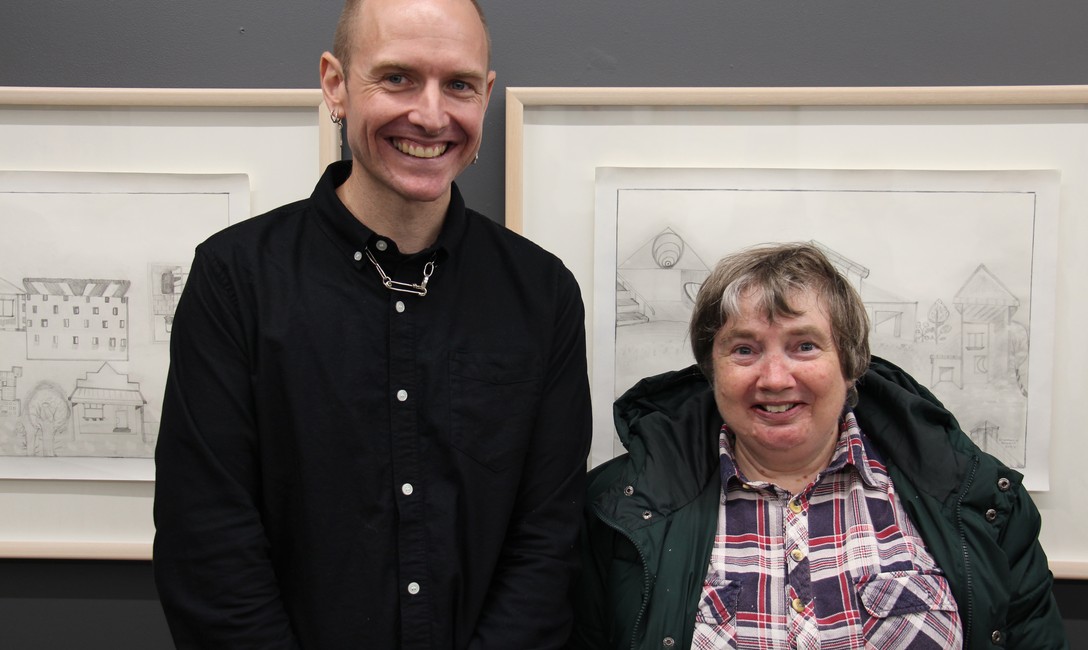 Curator Matt Gillies with artist Rosemarie Bowers in front of her artwork.