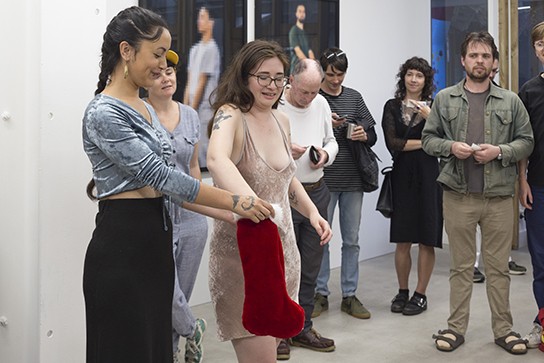 Mana Whenua Trustee Miriama Grace-Smith holds the Santa stocking while Enjoy director Vanessa Mei draws the winning raffle ticket, Buy Enjoy, 17 December 2020.