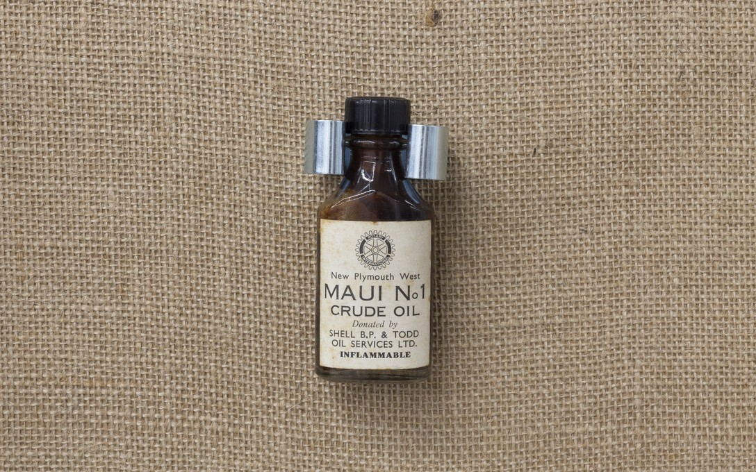 Fiona Clark, Gaslands and The Waitara Project, Maui Crude Oil, 1963. Bottle by New Plymouth West Rotary Club. Detail view. Courtesy of Cheska Brown.  