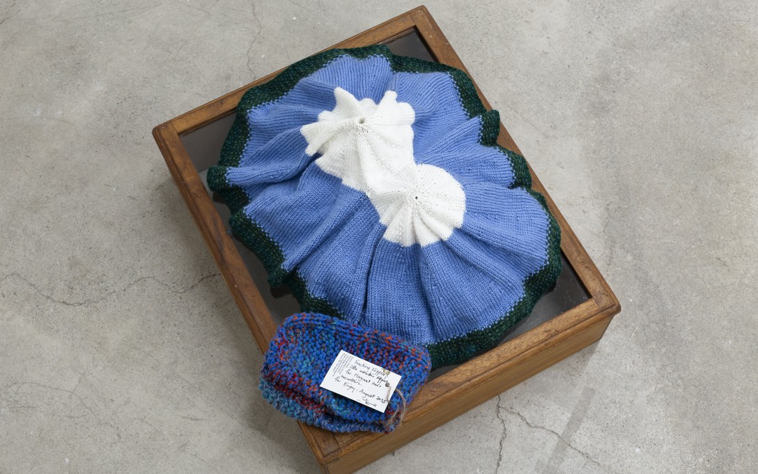 Margaret Ann White, Taranaki Maunga, 2019. Slippers knitted by Fiona Clark to match Taranaki mountain, 2025, titled Farcking Slippers or Little Mountain slippers, named by Margaret. Detail view. Courtesy of Cheska Brown.