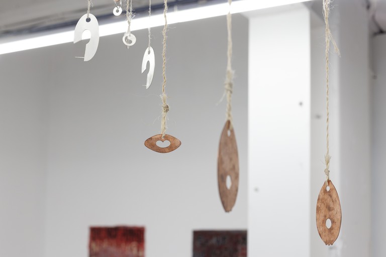 Aroha Matchitt-Millar, Tīwaiwaka takamiri turuma, he tangata kaikino (The spiteful, malicious person behaves like a fantail near the latrine, waiting for gossip as the fantail waits for insects attracted by the odour), 2024-2025. Tarp, muka, stirling silver, copper, Tīwaiwaka pelt, song thrush skin, acrilyc paint, rotting harakeke. Photo by Cheska Brown.